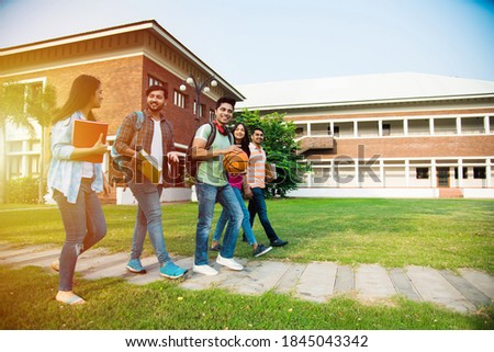 Cheerful Indian asian young group of college students or friends laughing together while sitting, standing or walking in campus Royalty-Free Stock Photo #1845043342