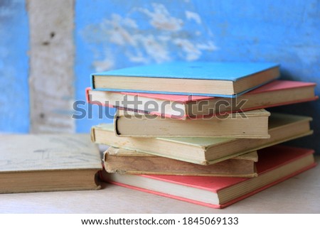 Close-up of many old book stacks on old wooden floors selective focus and shallow depth of field