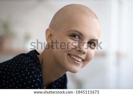 Head shot portrait close up overjoyed attractive hairless woman looking at camera, posing for photo, smiling healthy young female struggling with cancer, healthcare and successful treatment concept