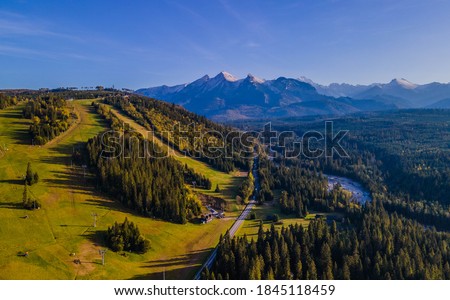 Autumn panoramic aerial view of Białka river valley with the Tatra Mountains in the background, border between Spisz and Podhale regions, drone photography