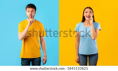 Young man gesturing hush sign, keep silence, smiling woman holding palm near mouth, making offer, screaming information at camera isolated over blue and yellow studio background wall