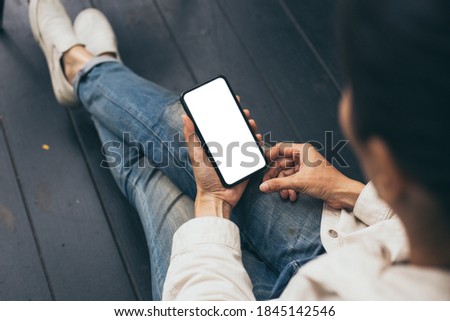 cell phone blank white screen mockup.woman hand holding texting using mobile at coffee shop.background empty space for advertise.work people contact marketing business,technology