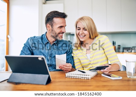 Happy couple managing home finances Royalty-Free Stock Photo #1845162400
