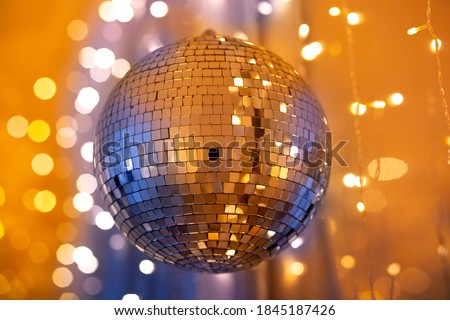 Disco ball for party for new year, golden and blue glow, flicker. Christmas day concept.