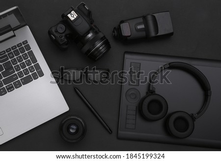 Photographer retouching equipment on black background. Top view. Flat lay