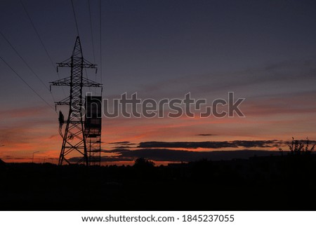 An electricity pole and a sunset