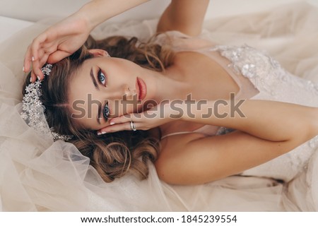 fashion portrait of beautiful bride with blond hair in luxurious wedding dress and accessories Royalty-Free Stock Photo #1845239554
