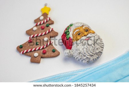 Christmas tree cookie, Santa and a mask, background with dark color