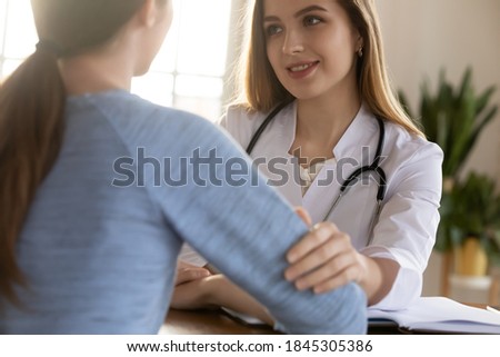Benevolent caring millennial woman general practitioner or psychologist supporting young girl customer, encouraging take cancer treatment, helping find patience strength for medical therapy, close up Royalty-Free Stock Photo #1845305386