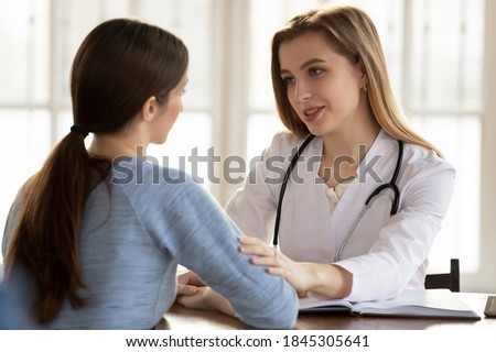 Understanding caring female doctor medical practitioner supporting comforting worried anxious young woman patient client of hospital, giving hope on good cure result, persuading in treatment success Royalty-Free Stock Photo #1845305641
