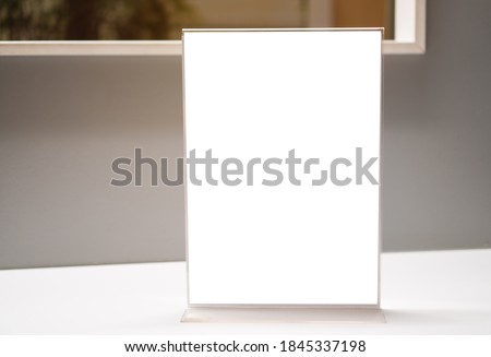 Stand White mockup acrylic frame tent card on counter reception in seminar check in for register, background layout insert space for text of information