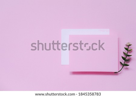 top view of blank pink greeting card on pink background, greeting cards ideas for Christmas and celebration season concept with copy space.