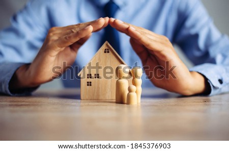 The insurance agent presents the toys that symbolize the coverage,Insurance house,family health live concept. Royalty-Free Stock Photo #1845376903