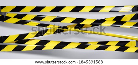 Lockdown. Do Not Cross criminal area. Yellow and black warning police strip line isolated on gray background. Caution lines. Danger and risk tape. Industrial protection sticky tape. Set small signs