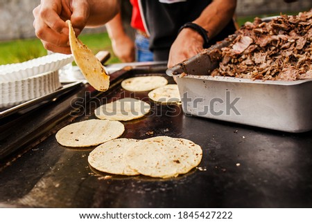 Taquero is Mexican man making tacos al pastor in Taqueria at Mexico city
