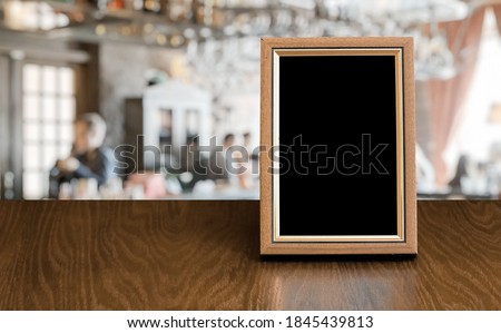 old photo frame on the wooden table in a night club