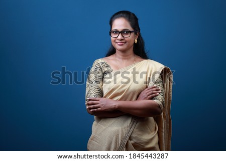Portrait of a happy woman of Indian origin wearing traditional dress Sari Royalty-Free Stock Photo #1845443287