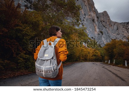 Outdoor fashion photo of young beautiful asian lady surrounded autumn forest in mountains. Portrait of romantic hipster female, Warm autumn weather, calm scene. Wanderlust photo series.
