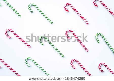 Christmas candy lollipop pattern isolated on white background. Flat lay, top view, copy space. Christmas, winter, new year concept. Christmas composition for design.