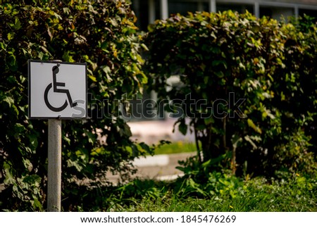 Road sign on a background of asphalt. Disabled parking. The texture of the tarmac, top view.