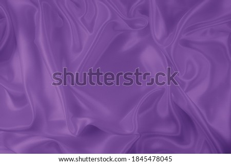Beautiful elegant wavy violet purple satin silk luxury cloth fabric texture, abstract background design. Card or banner.