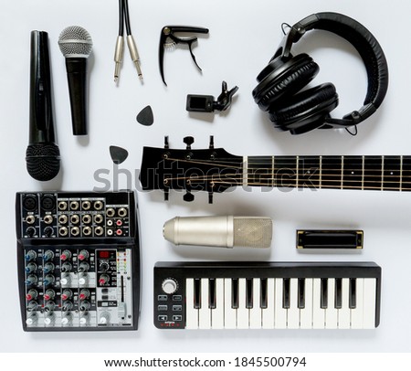 Black and white flat lay composition. Portable and compact music home studio for music production. Top view on professional audio devices