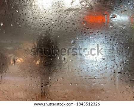rain on the road from car window, dangerous vehicle driving in rainy. Abstract blurred bad weather car