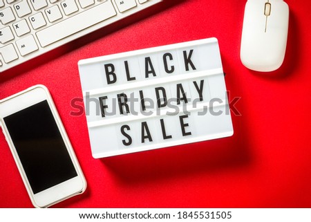 Black friday sale concept with laptop and smartphone at red background. Online shopping. Top view.