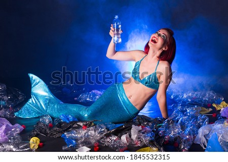 Ocean plastic pollution. Mermaid have fun in water with plastic garbage. Stop plastic pollution. Fairy tale and reality concept.