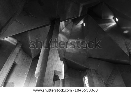Black and White tone and mood, Detail of rough raw concrete ceiling with abstract geometric patterns with light and shadow of brutalist architecture church. Royalty-Free Stock Photo #1845533368