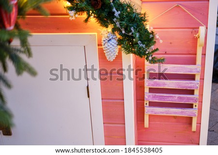 Old sledges hang on the wall of a wooden house. Preparing to celebrate the new year and christmas