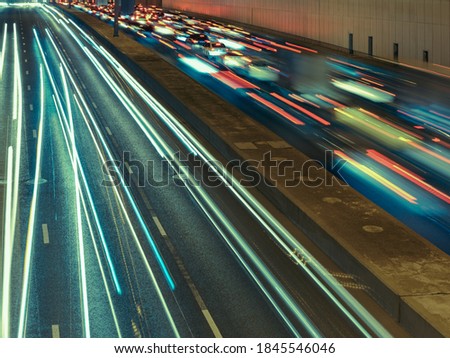 Long exposure photography. Defocused photography of Moscow cityscape in night time. Big traffic. Street is filled by cars. Blurred motion of cars at motorway. Frontal back ear view