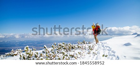 Father holding small son in snow in winter nature, holiday concept. Copy space.