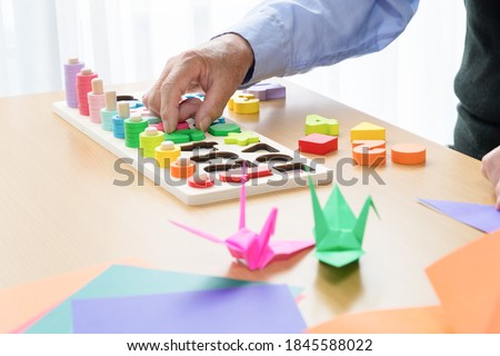 Old man rehabilitating with occupational therapy Royalty-Free Stock Photo #1845588022