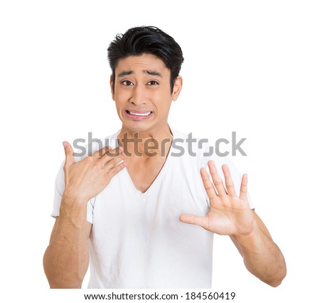 Closeup portrait, worried young man gesturing with hand to stop talking, cut it out, dont go there, isolated white background. Negative emotion facial expression feelings, signs symbols, body language