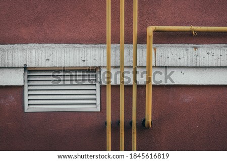 Abstraction yellow pipes, white stripe on the wall, ventilation.