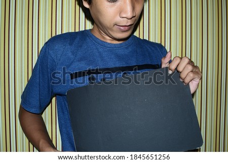 Asian teen holding black board with style