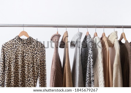 colorful sweater with leopard and Animal, zebra
pattern long sleeve shirt on hanger

