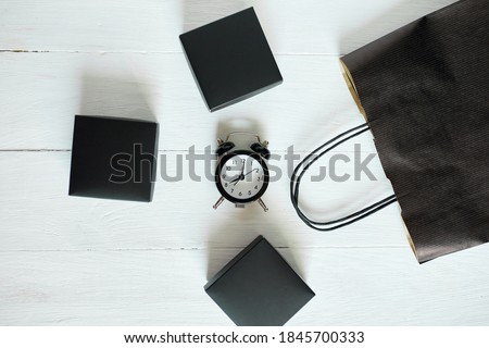 Black paper shopping bag with clock on white background