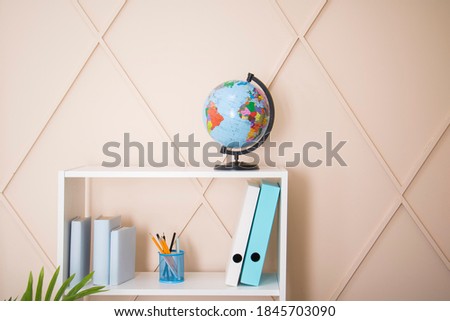 
Office interior, globe and plastic file folders