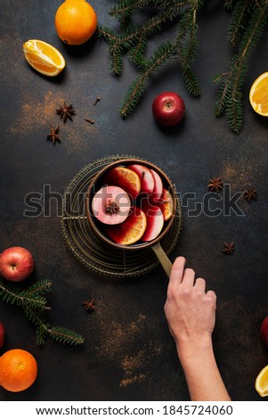 Winter mulled wine with orange, apple, cinnamon and anise star, winter concept