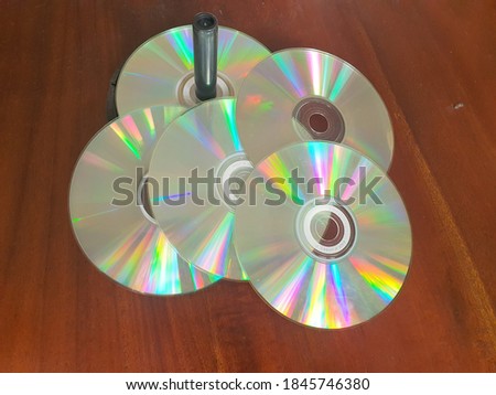 several compact disks were placed on the table