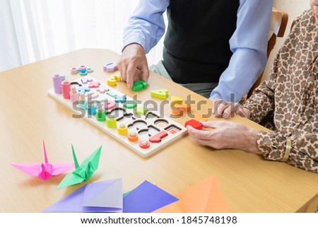 Old man rehabilitating with occupational therapy Royalty-Free Stock Photo #1845748198
