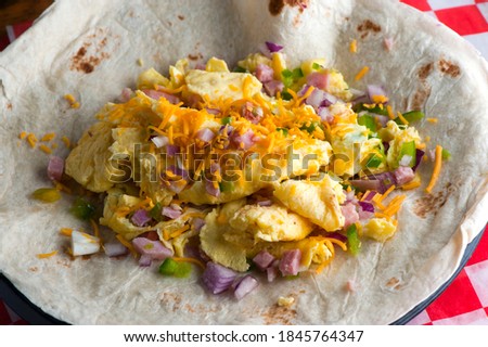 Breakfast Tacos Tex-Mex favorite. Mexican tacos with eggs beef, pork, served on homemade corn tortilla. Seasoned tender meat, fresh avocado cilantro queso freasca and homemade salsa and lime slices. 