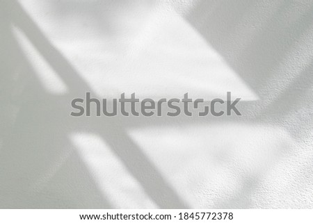 Abstract light reflection and grey shadow from window on white wall background , dark gray and sunshine diagonal geometric effect overlay for backdrop and mockup design
