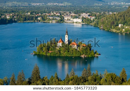 A picture of the Bled Island in the middle of Lake Bled, as seen from a vantage point.