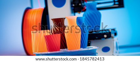 3D Printer Plastic filament for 3D printer and printed products in the interior of the design office Royalty-Free Stock Photo #1845782413