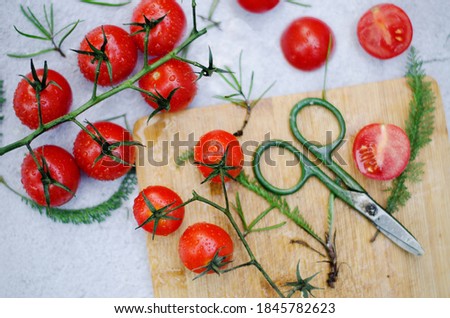 Food photography of fresh cherry tomatoes with herbs on a dark background at table close up. Flat lay. Top view. 