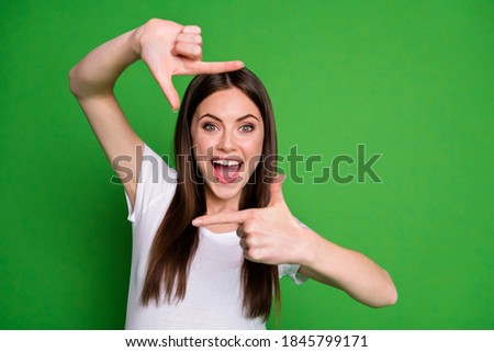 Photo of charming energetic girl wear white t-shirt making photo fingers open mouth isolated green color background