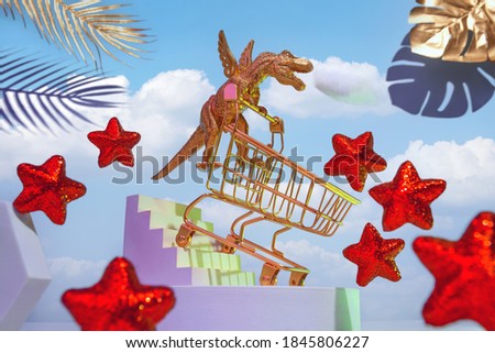A golden dinosaur on wings with a trolley descends the stairs for shopping, around the sky, red stars, palm leaves, the concept of a big sale, Black Friday.